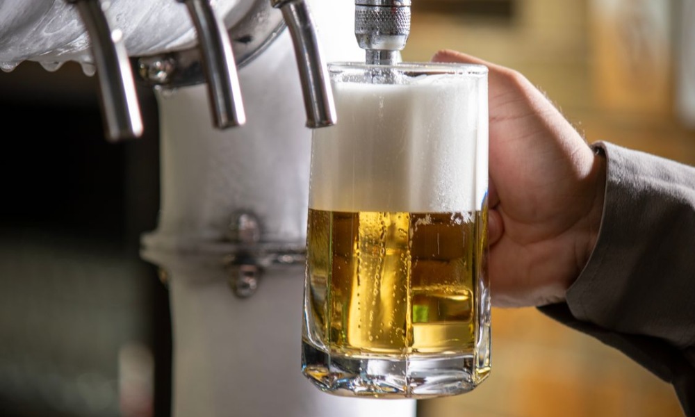 a glass mug being filled with fresh beer
