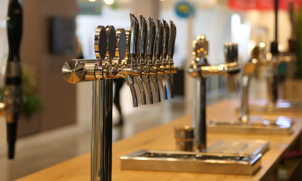A row of polished chrome beer taps