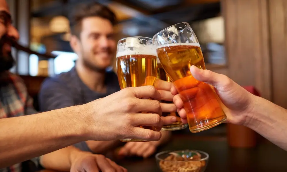 clinking tall glasses of golden beer
