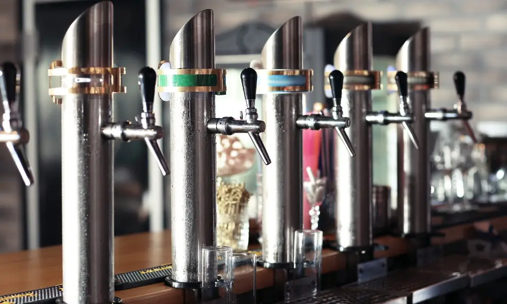 row of polished metallic beer taps